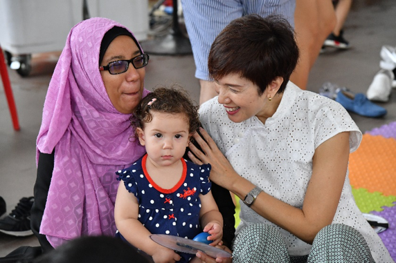 Minister Josephine Teo interacting with families during the mass parent-child activity.