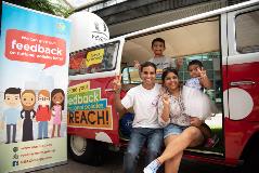 Family posing for a photo at the REACH VoxWagen
