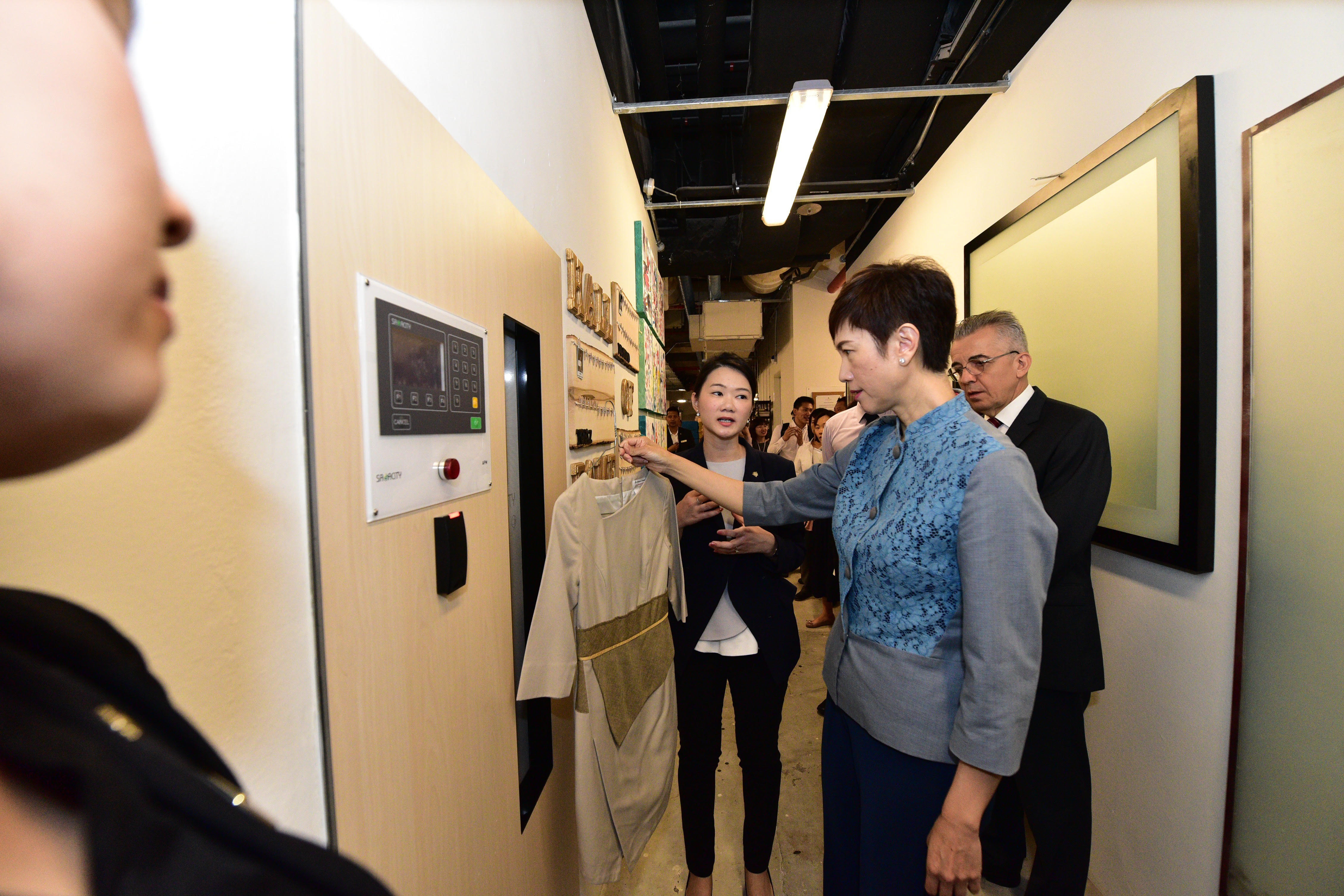 Minister Josephine Teo understanding how hotel staff get their fresh uniform every day via the employees’ RFID Automated Uniform Control System.