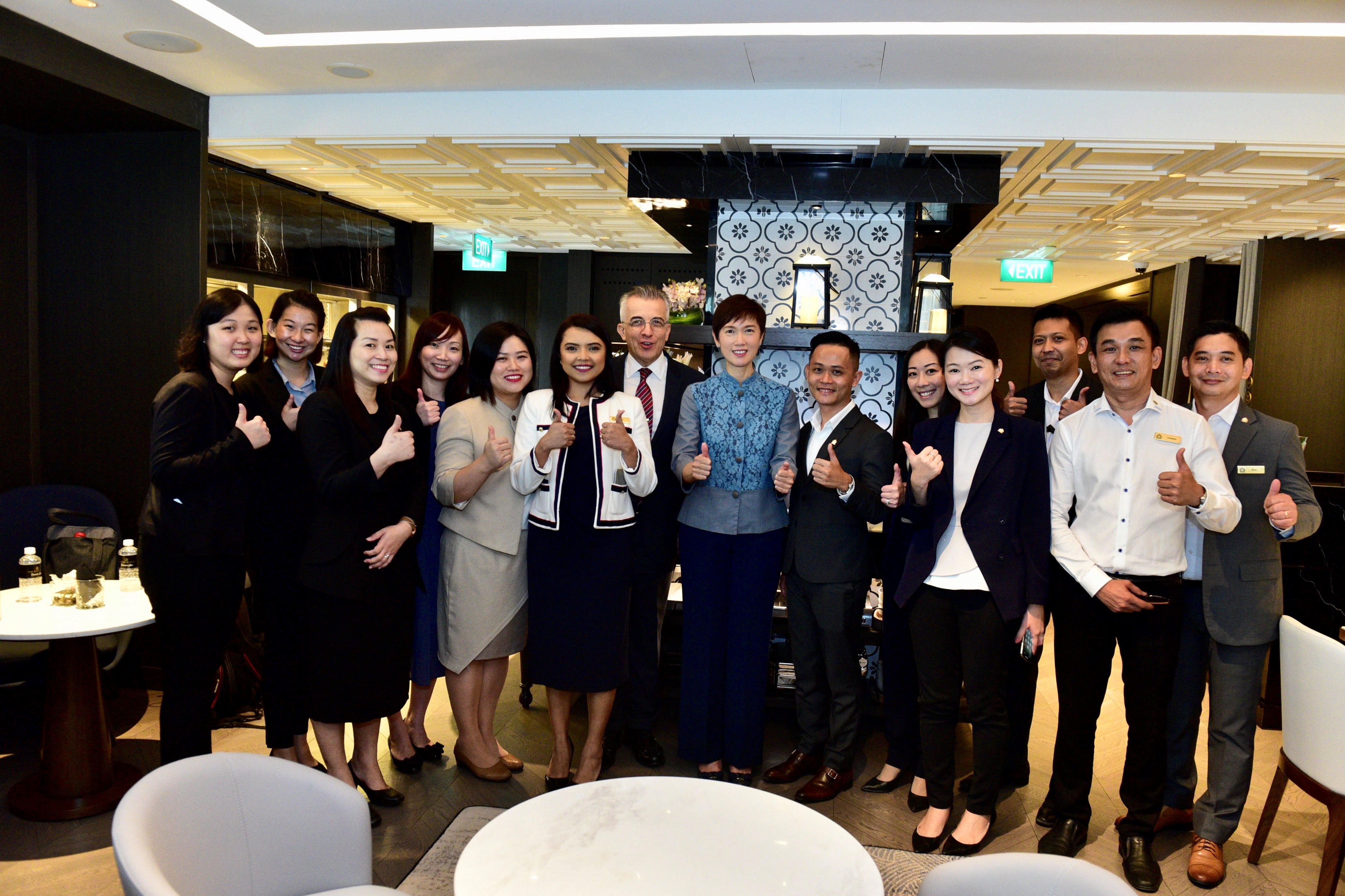 Minister Josephine Teo with senior management and hotel staff.