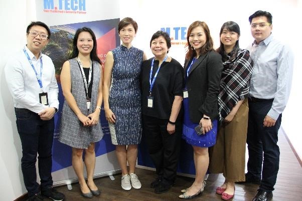 Minister Josephine Teo taking a group photo with M. Tech staff.